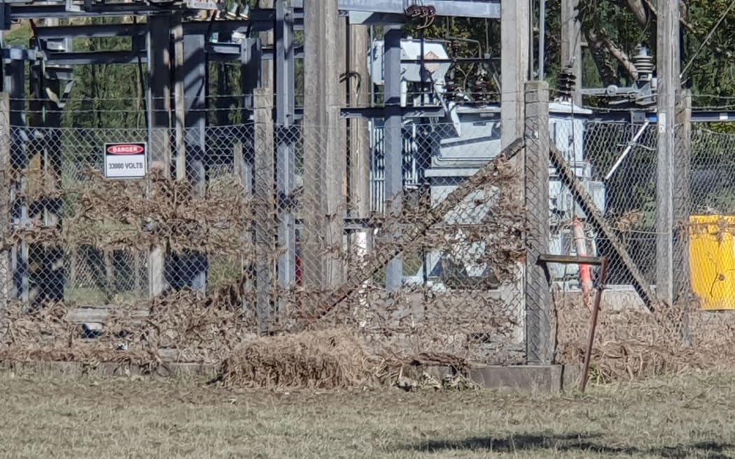 Floodwaters left grass stuck in the Tinui substation fence. Power is now back on.