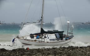 The storm in Majuro has blown yachts moored in the usually placid lagoon onto the shore.