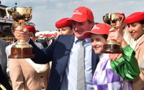 Jockey Michelle Payne (right) and trainer Darren Weir (left) of Australia hold up their Melbourne Cups after winning the race on Prince of Penzance at Flemington Racecourse in Melbourne in 2015.