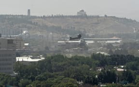 A US military helicopter is pictured flying above the US embassy in Kabul on August 15.