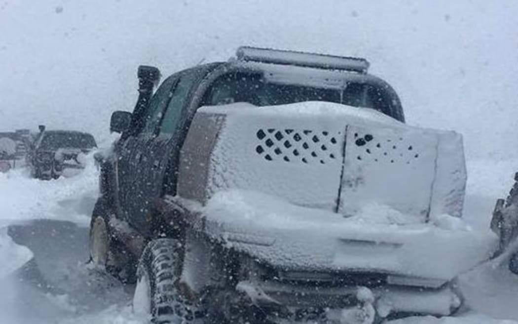 A helicopter is still trying to rescue 36 people trapped in vehicles on a remote, snow-filled road in in Central Otago but it can't land.