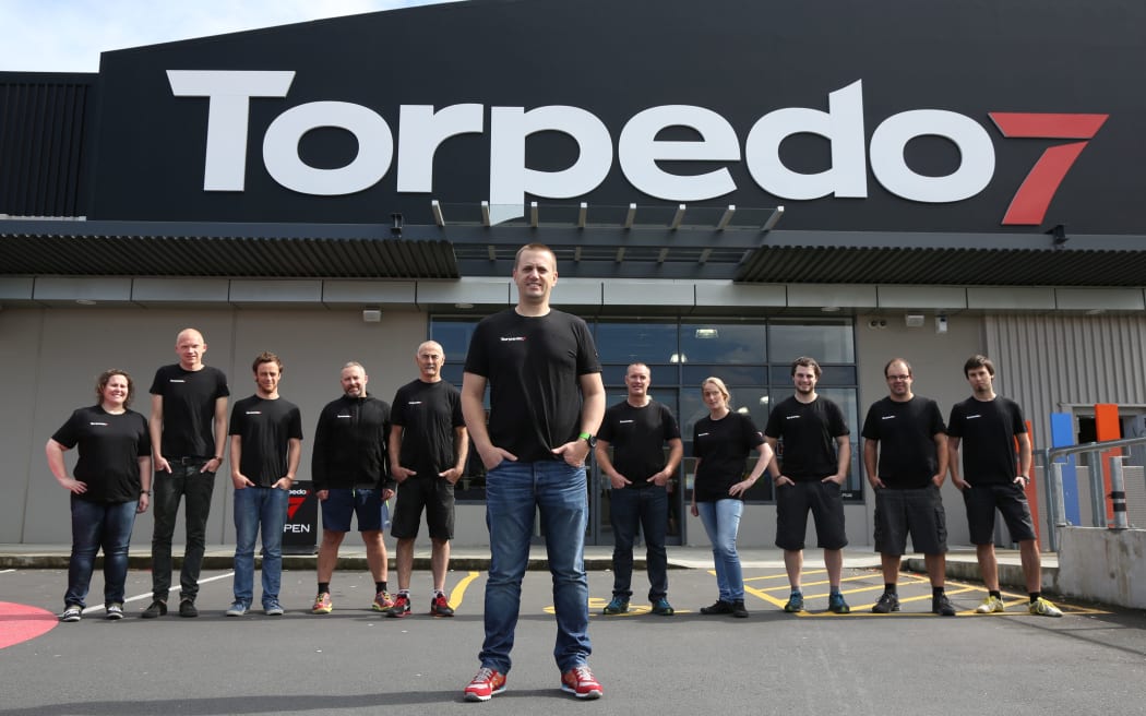 Aaron Greene Torpedo 7 COO (front) with store team members and management.