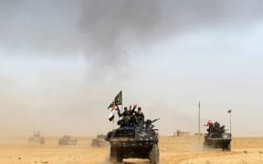 Iraqi forces deploy on October 17, 2016 in the area of al-Shurah, some 45 kms south of Mosul, as they advance towards the city to retake it from the Islamic State (IS)