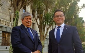New Zealand First MP Mahesh Bindra and Labour MP Raymond Huo standing outside Parliament.