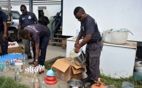 Solomon Islands police with seized kwaso.