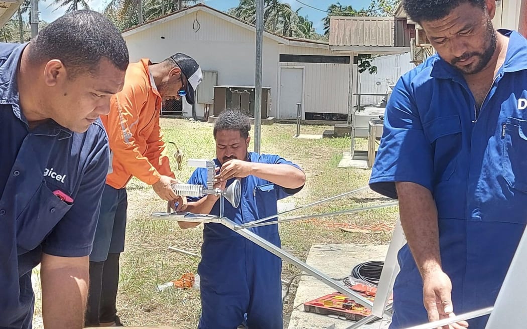 Digicel Tonga’s technical team working on satellite link equipment to restore internet connection