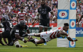 Japan's Kotaro Matsushima scores as his side defeats Fiji 34-21 at Kamaishi Recovery Memorial Stadium