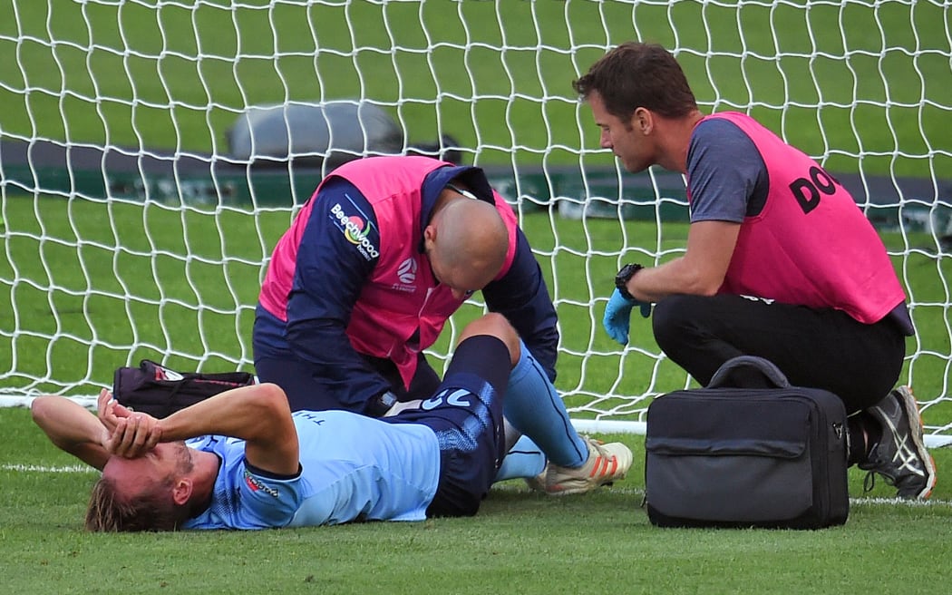 Sydney FC's Siem De Jong is treated by medical staff after scoring a goal.