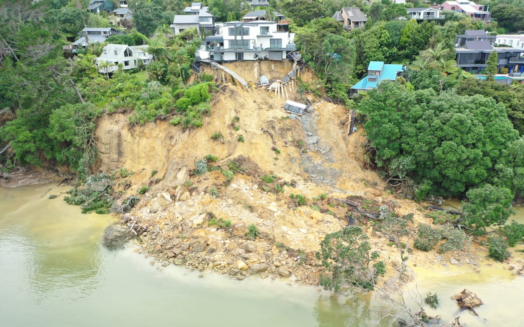 A land slip is seen below a house on Brigantine Drive in Beach Haven following torrential rains which caused widespread flooding across Auckland in January 2023.
