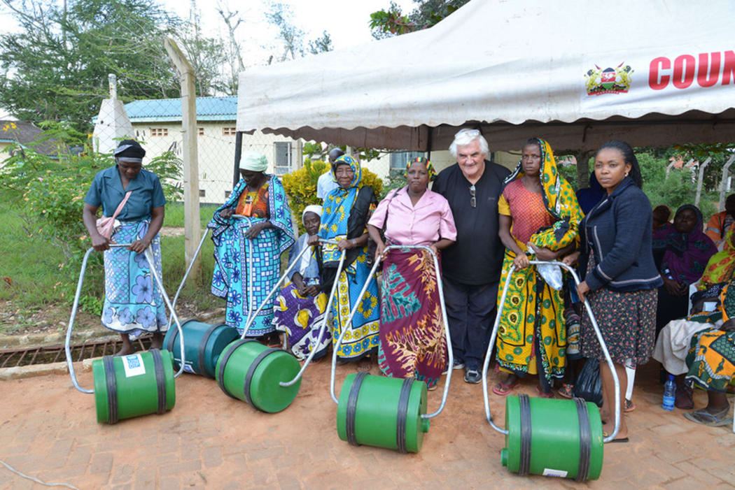 Roll Out the Barrel founder Adrian Brewer poses with barrel recipients in Kenya.