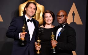 Producers Jeremy Kleiner, left, and Adele Romanski, pose with 'Moonlight' filmmaker Barry Jenkins after their win.