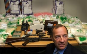 Detective Inspector Bruce Good with New Zealand's largest drug haul, $95million worth of Methamphetimine which was intercepted as it was imported into the Country. A raid on a house found the arms and ammunition on the table. 25 May 2006.