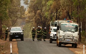 PERTH, AUSTRALIA - FEBRUARY 06: Parks and Wildlife crew secure a Reene Road in Gidgegannup on February 06, 2021 in Perth, Australia. Fire crews have managed to contain almost all of the bushfires that have been burning across the Perth hills for the last five days. The fires destroyed 86 homes and burned through almost 11,000 hectares of land. (Photo by Paul Kane/Getty Images)