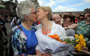 Irish Senator Katherine Zappone (L) kisses her partner Ann Louise Gilligan at Dublin Castle.