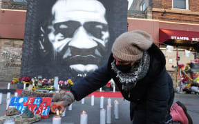Community activists light candles at a memorial near the site where George Floyd died on March 28, 2021 in Minneapolis, Minnesota.