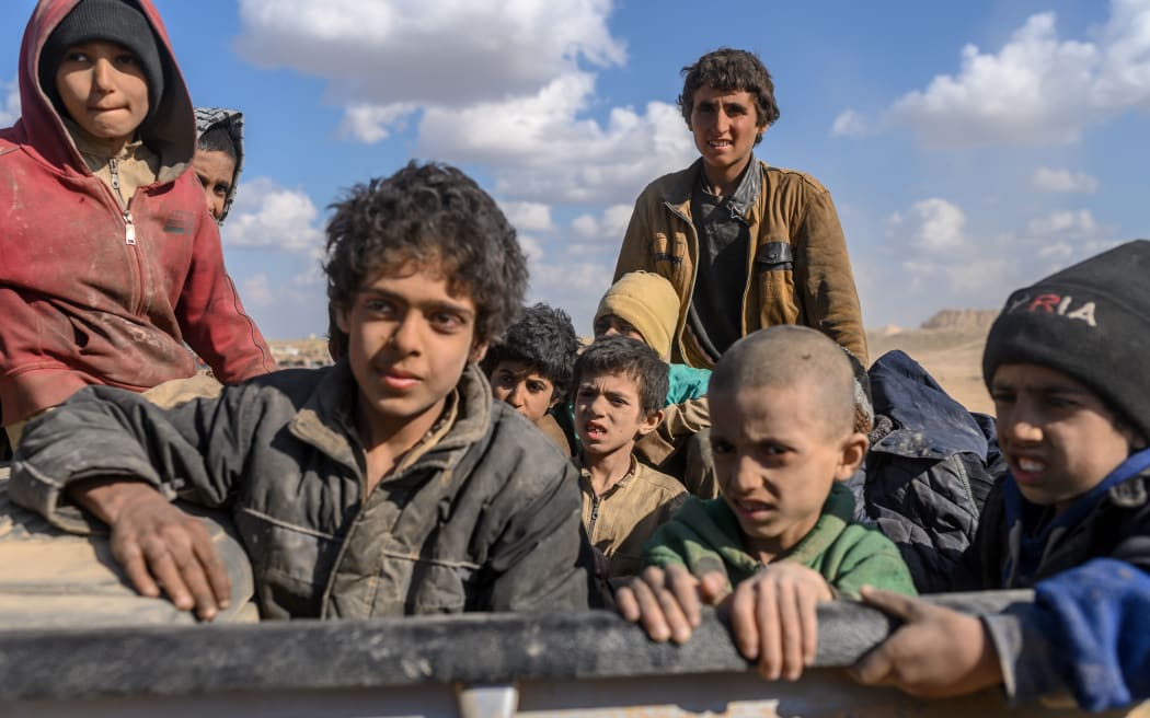 Children who were captured by Islamic State (IS) group fighters, believed to be from the Yazidi community, are pictured after being evacuated from the IS' embattled holdout of Baghouz