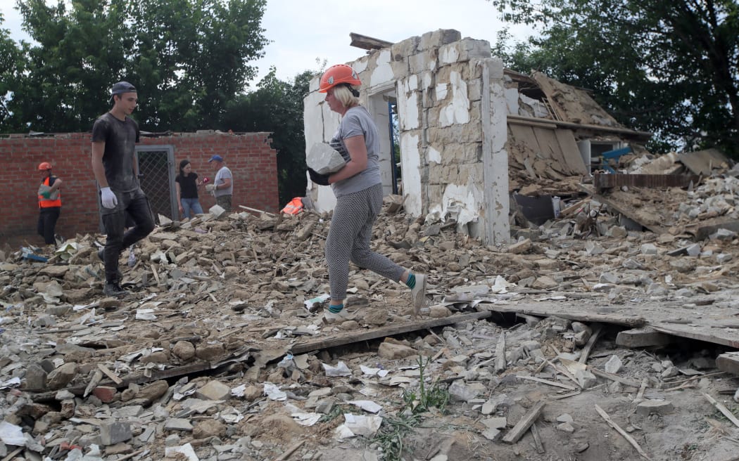 BOROMLIA, UKRAINE - JUNE 17, 2022 - Volunteers help rescuers clear away the rubble at buildings destroyed by Russian invaders, Boromlia village, Sumy Region, northeastern Ukraine. This photo cannot be distributed in the Russian Federation. NO USE RUSSIA. NO USE BELARUS. (Photo by Pavlo_Bagmut / NurPhoto via AFP)