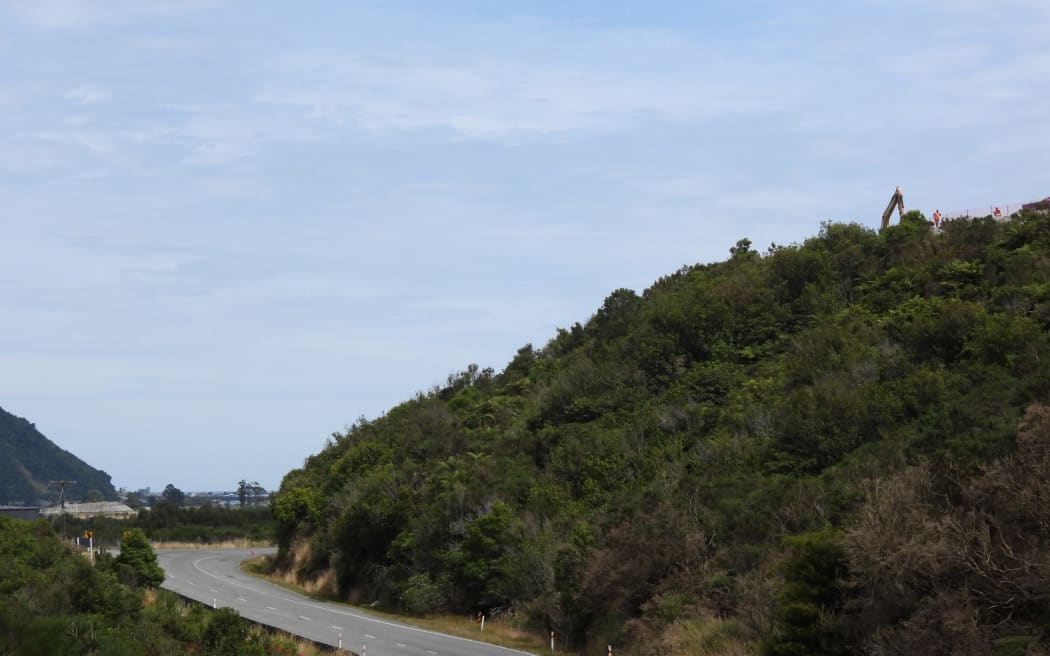 Looking west along Taylorville Road, the Greymouth water source and treatment station can be seen at left, middle distance, while the refuse facility with heavy machinery can be seen on the ridge line, right.