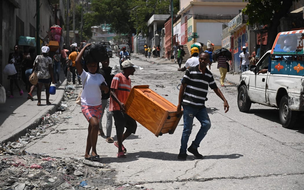 Resident evacuate the Carrefour Feuilles commune in Port-au-Prince, Haiti, on 15 August 15, 2023, as gang violence continues to plague the Haitian capital.