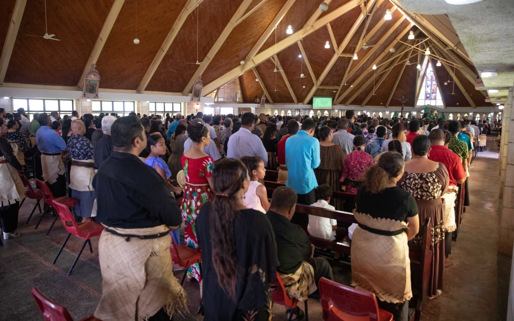Tongan's gather at St Mary's Cathedral in Nukualofa to commemorate the one year anniversary of the eruption and tsunami.