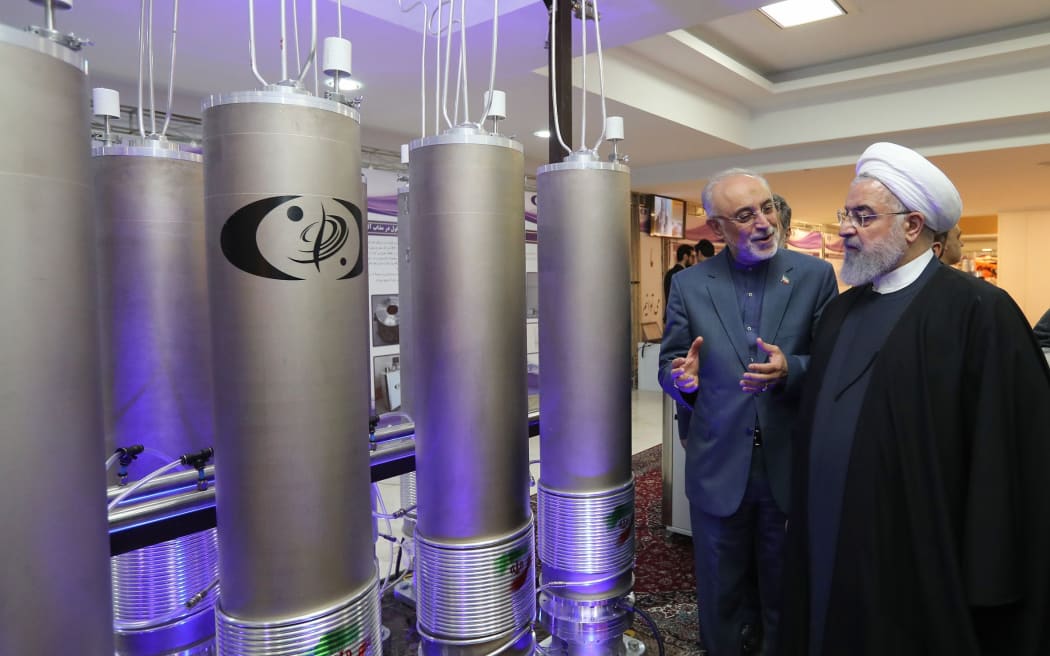 Iranian President Hassan Rouhani (right) listening to head of Iran's nuclear technology organisation Ali Akbar Salehi (second from right) during the "nuclear technology day" in Tehran on April 9, 2019.