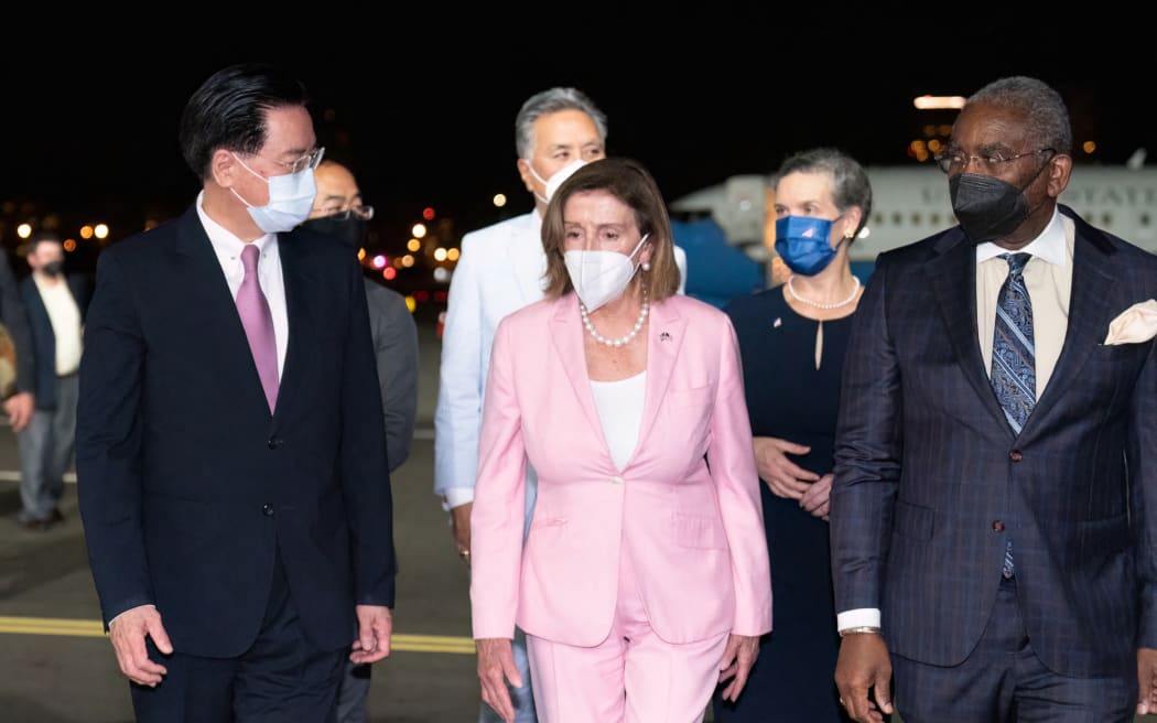 This handout picture taken and released by Taiwan’s Ministry of Foreign Affairs (MOFA) on 2 August 2022 shows Speaker of the US House of Representatives Nancy Pelosi being welcomed on her arrival at Sungshan Airport in Taipei.