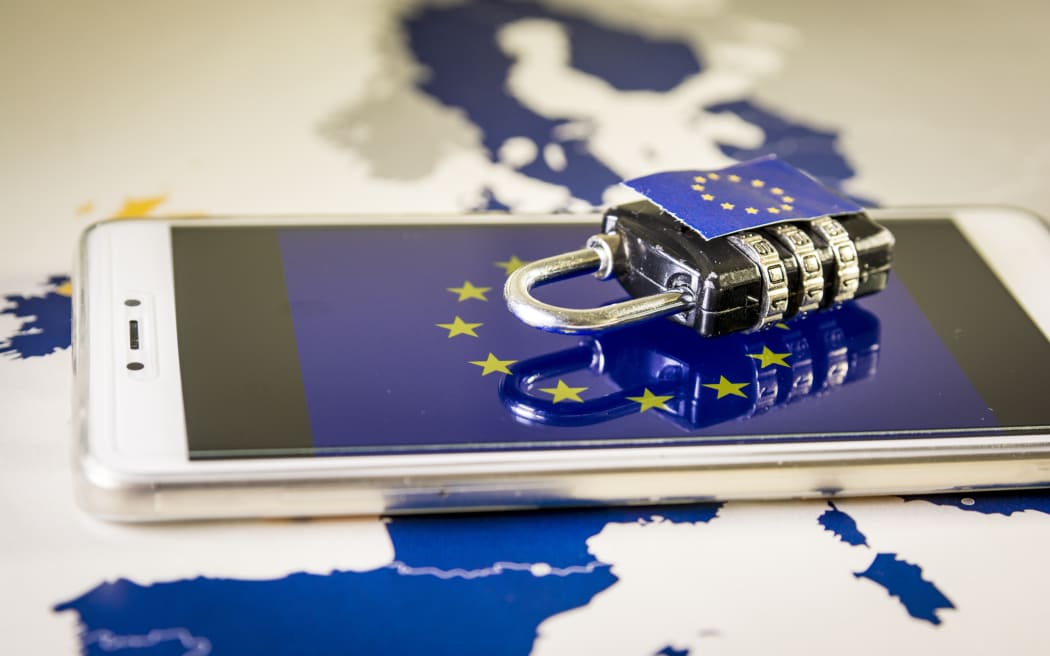 Padlock over a smartphone and EU map, symbolizing the EU General Data Protection Regulation or GDPR. Designed to harmonize data privacy laws across Europe.