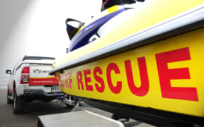 A Surf Life Saving lifeguard rescue boat is towed to Muriwai Beach, Auckland.
