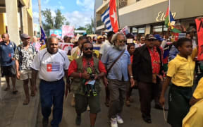 Hundreds of ni-Vanuatu, and West Papuan representatives, march to the Melanesian Spearhead Group secretariat in Port Vila.