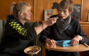 Pip Cook feeds her severely disabled foster son Ryan.