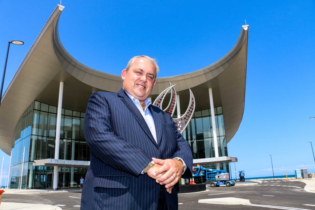 Papua New Guinea APEC minister Justin Tkatchenko standing infront of APEC House in Port Moresby.
