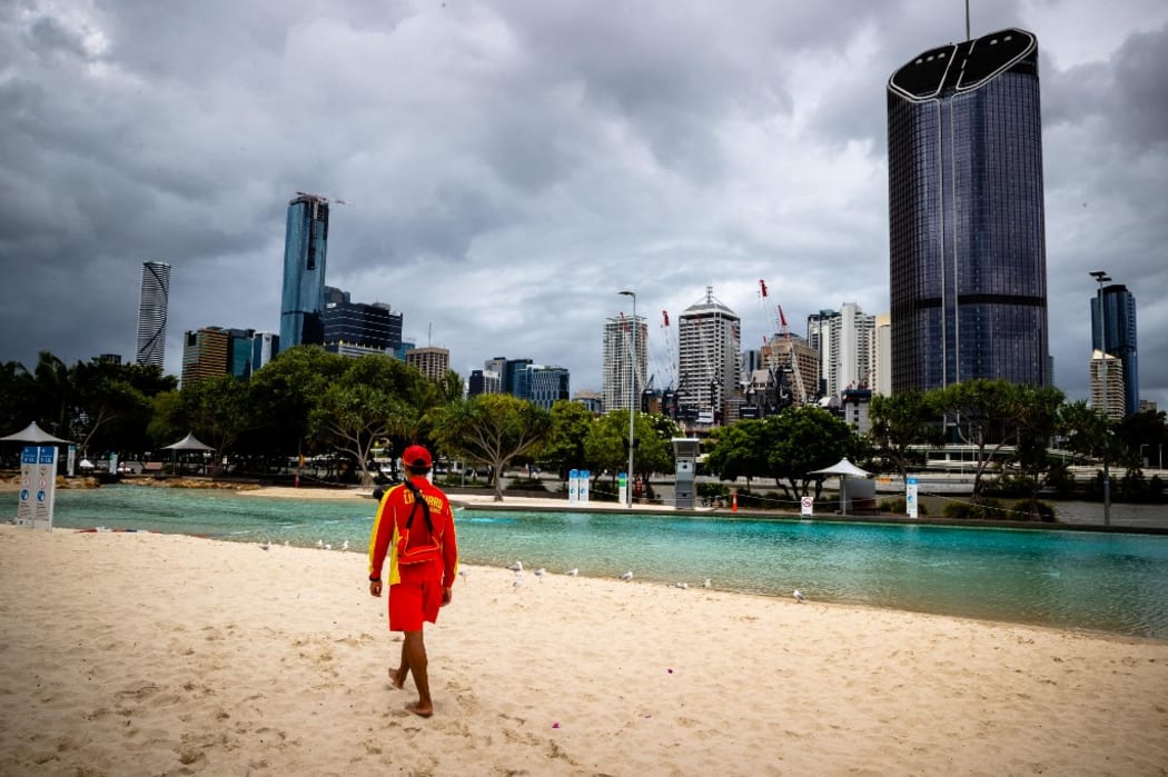 A lifeguard stands watch over a deserted South Bank beach on the first day of a snap lockdown in Brisbane on January 9, 2021.