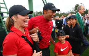 Tiger Woods celebrates with daughter Sam and son Charlie after winning The 2019 Masters golf tournament at Augusta National Golf Club.