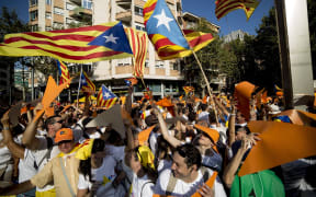 Demonstrators wave "Estelada" flags (pro-independence Catalan flags) during celebrations of Catalonia's National Day.