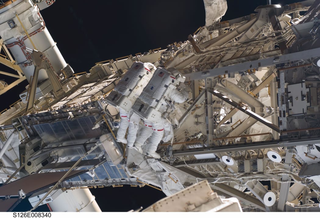 In this second spacewalk for the STS-126 mission, astronauts Heidemarie Stefanyshyn-Piper (left) and Shane Kimbrough continued the process of removing debris and applying lubrication around the starboard Solar Alpha Rotary Joint (SARJ)