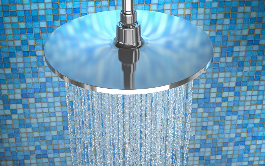 detail of water coming out of the shower of a shower with blue mosaic tiles. nobody around. 3d render. view from top.