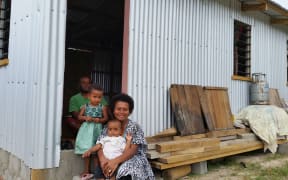 Maraia Waqa with her family and new home.