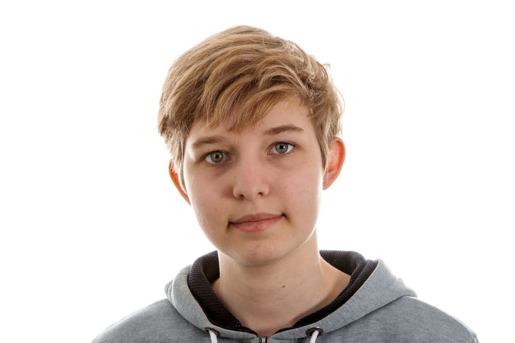 A closeup photo of transgender boy with slightly different background