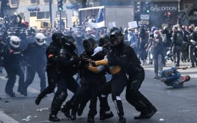 French riot police forces detain a protester during a rally as part of the 'Black Lives Matter' worldwide protests against racism and police brutality.