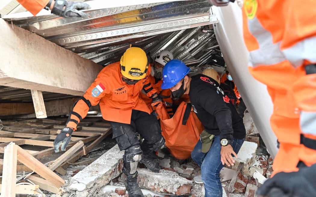 Rescuers work in Cianjur on 22 November, 2022, following a 5.6-magnitude earthquake.
