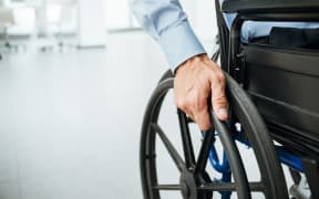 close-up of hand and wheelchair