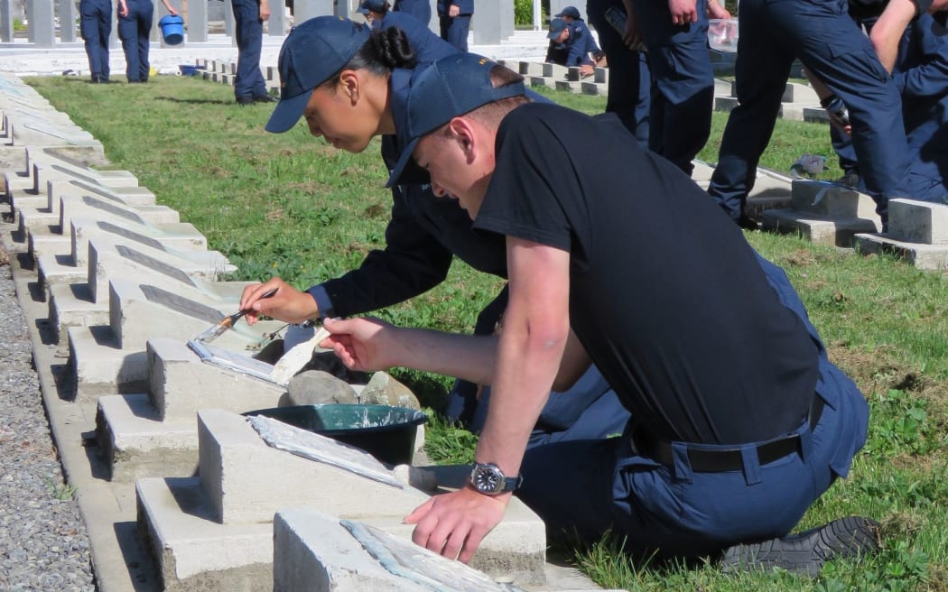 RNZAF recruits at Omaka Cemetery restore war grave plaques.