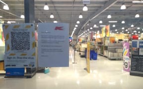 A sign on the door of Kmart Botany notifies customers the store is closed for cleaning due to a Covid-19 case.