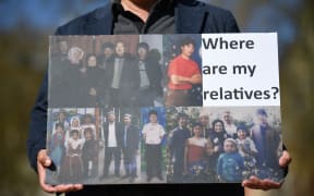 A member of the Uyghur community holds a placard as he joins a demonstration to call on the British parliament to vote to recognise alleged persecution of the Uyghur people as genocide and crimes against humanity in London on April 22, 2021.