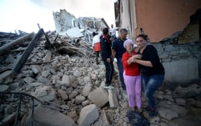 Residents among the rubble after a strong eartquake hit Amatrice on August 24, 2016 Central Italy was struck by a powerful, 6.2-magnitude earthquake in the early hours, which has killed at least three people and devastated dozens of mountain villages.