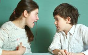 teen siblings boy and girl arguin close up photo