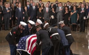 The casket containing the remains of former United States President George H.W. Bush arrives at the US Capitol. Monday, December 3, 2018.