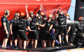 Team New Zealand celebrate victory in race 10 and winning the America's Cup.