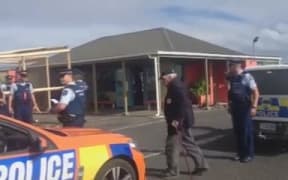 Māori Battalion veteran Selwyn Clarke being taken away by police at Kaitaia Airport.