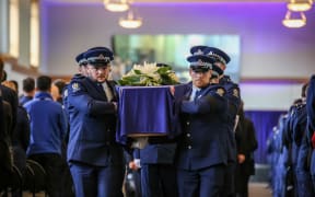 Police colleagues carry the casket of Constable Matthew Hunt at his funeral on 9 July.